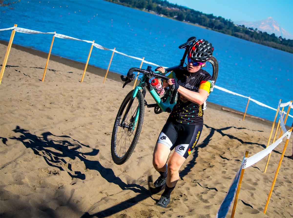 Pacific NW bicycle racing official Oregon one CX racer runs over obstacle while another bunny hops the barriers