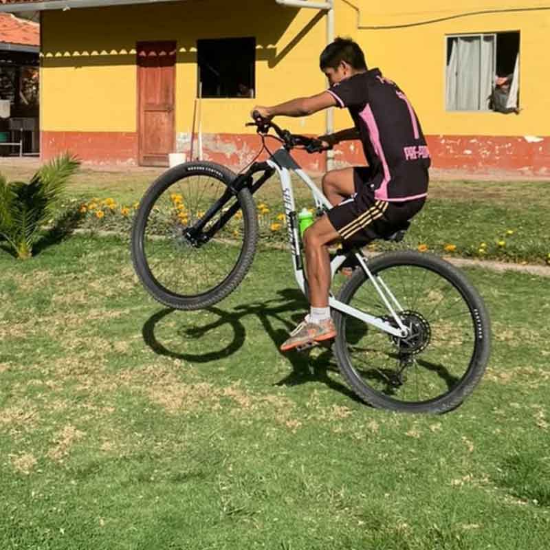 Edwin pictured in Peru on a mountain bike Mike bought for him to better match his talent and hard work.